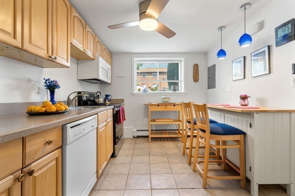 64 Bryon Road, Unit B641 Boston, MA 02467 - Photo 8 of 26 a kitchen with stainless steel appliances granite countertop a sink and cabinets