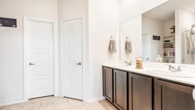 a bathroom with a double vanity sink and a mirror