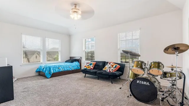 a living room with furniture a window and gym equipment