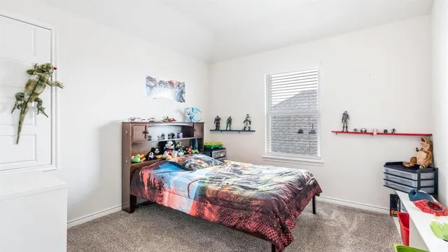 a bed room with a bed and a potted plant