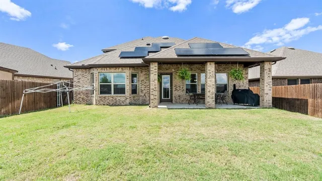 a view of a house with a porch and a yard