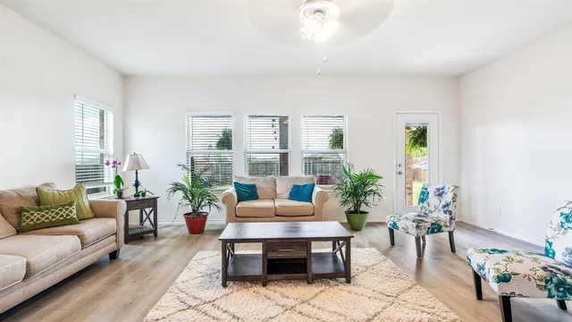 a living room with furniture and a potted plant