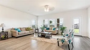a living room with furniture and wooden floor