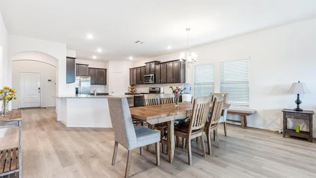 a view of kitchen dining table and chairs