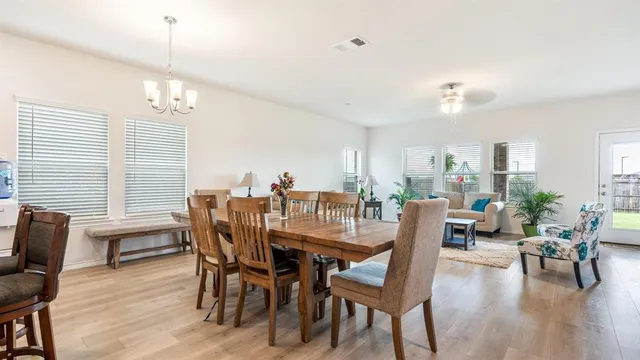 a dining room with furniture window and wooden floor