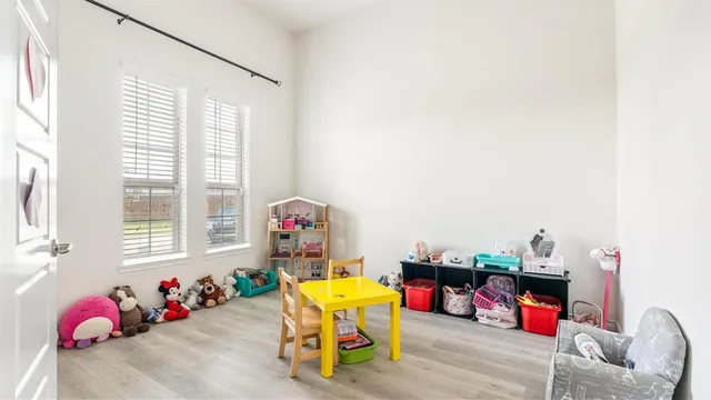 a living room with baby toys and furniture