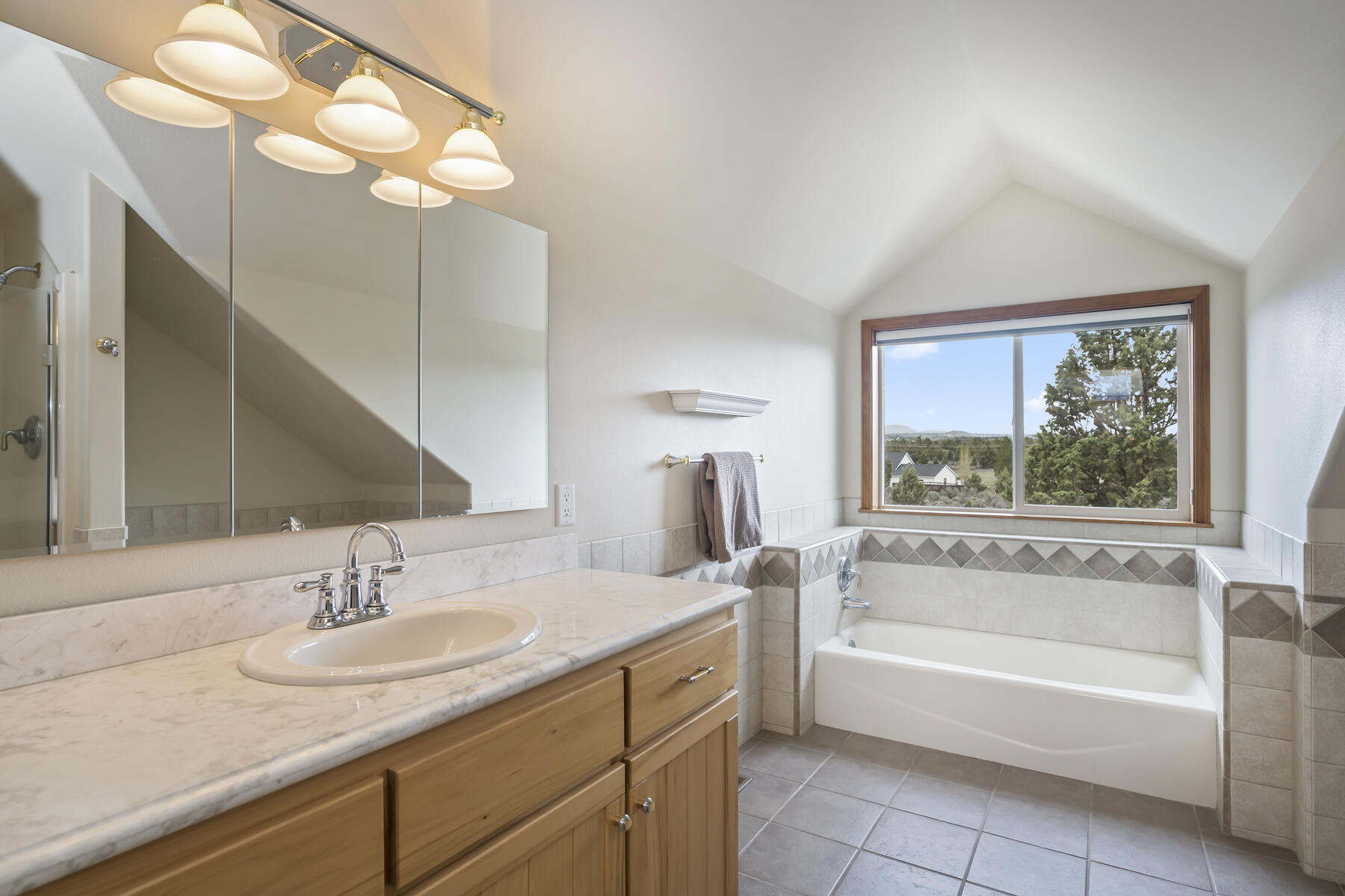 60850 Jennings Road Bend, OR 97702 - Photo 35 of 52 a bathroom with a tub sink and mirror