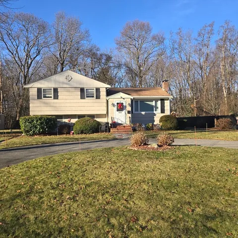 a white house that has a tree in it