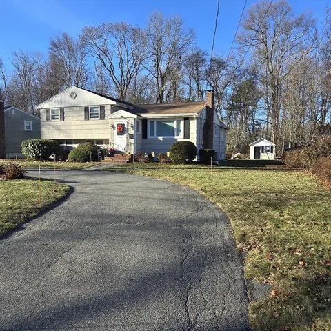 a front view of a building with garage and yard