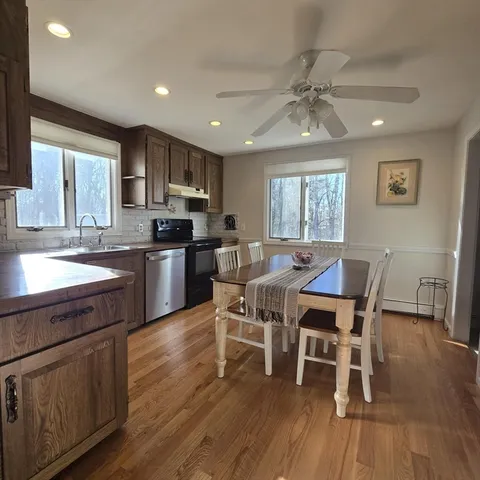 a large kitchen with a table and chairs