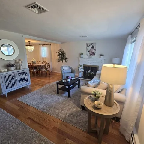 a living room with furniture a rug and a fireplace