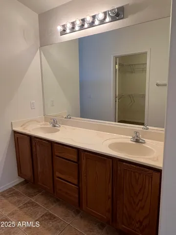 a bathroom with a double vanity sink and a mirror