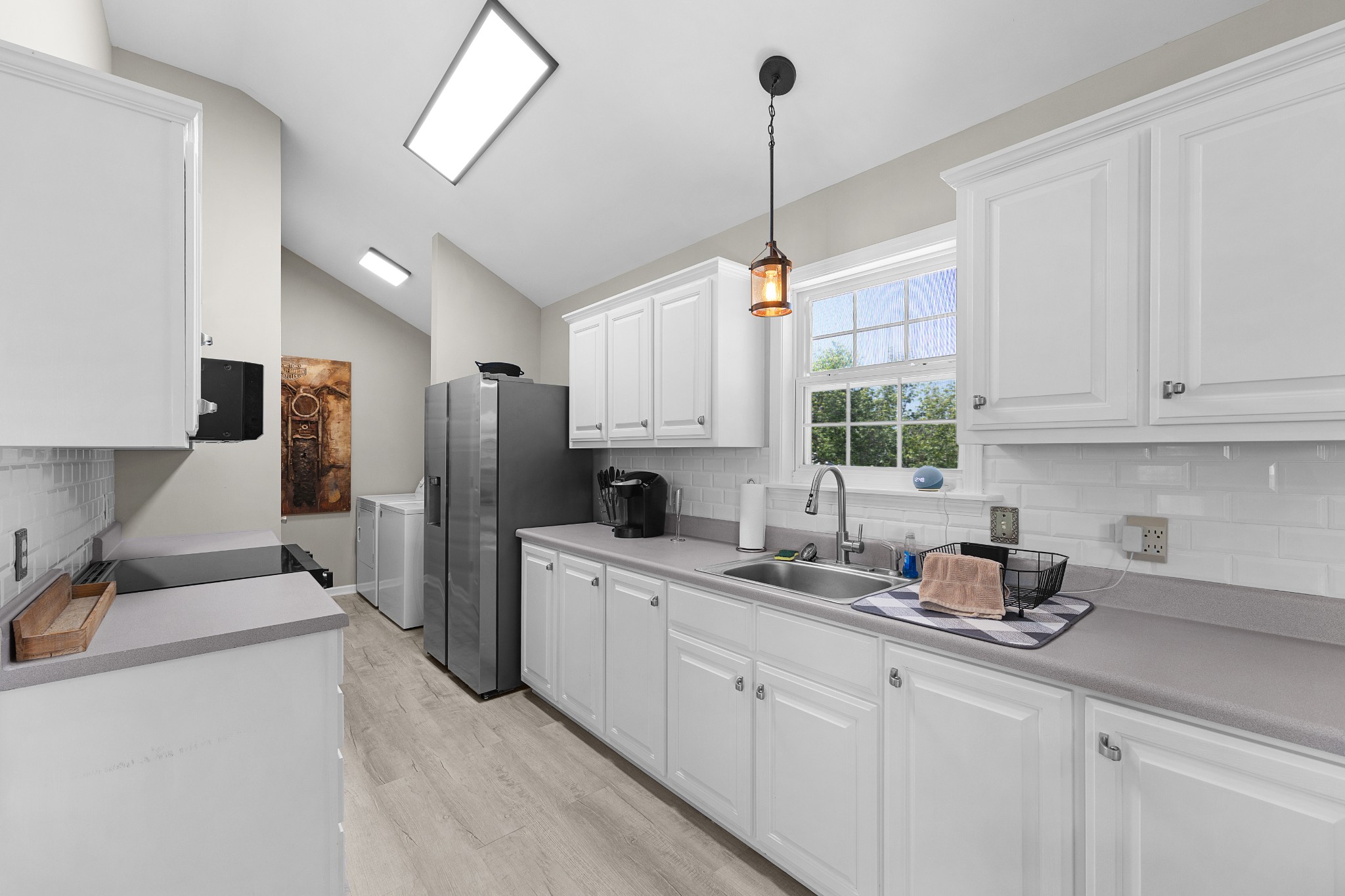 958 Pevahouse Camp Lane Decaturville, TN 38329 - Photo 12 of 32 a kitchen with white cabinets and stainless steel appliances