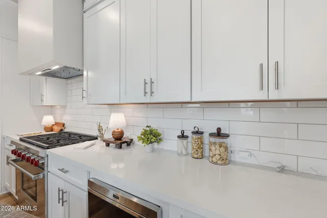 a kitchen with a sink cabinets and white appliances