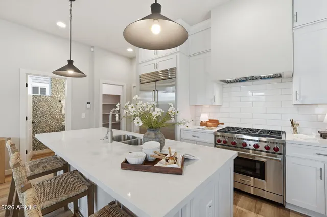 a kitchen with a table a stove and cabinets