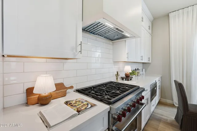 a kitchen with a stove and a cabinets