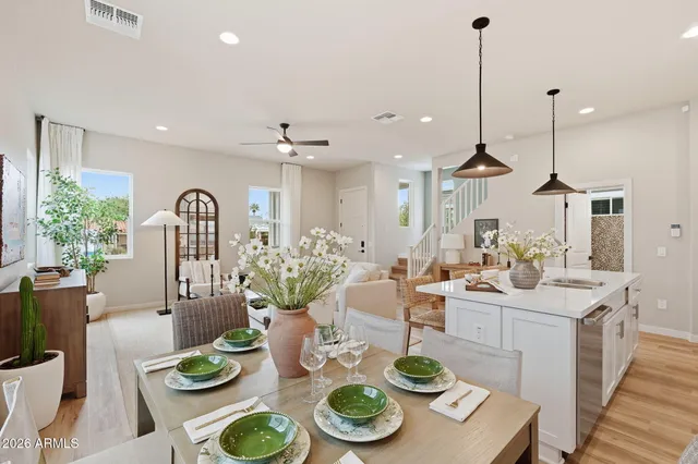 a very nice looking dining room with furniture a rug and wooden floor