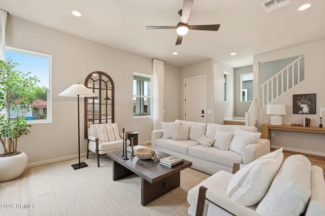 a living room with furniture and a large window
