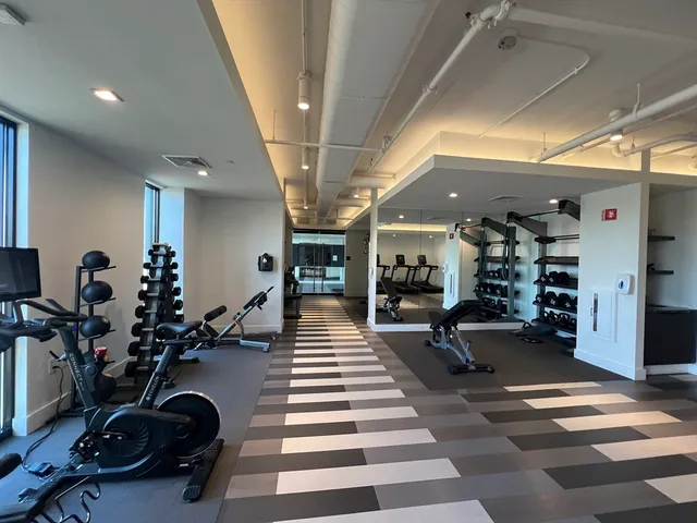 a gym room with lots of gym equipment