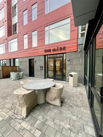 a view of a brick building with a bench in front of building