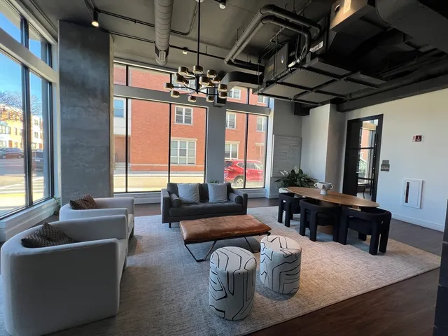 a living room with furniture a chandelier and a fireplace
