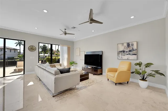 a kitchen with a sink a counter top space and living room view