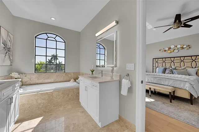 en empty room with ceiling fan and window