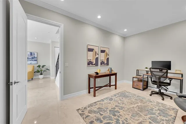 a view of an entryway with workspace and livingroom view