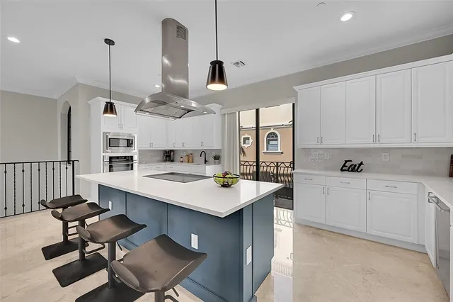 a kitchen with a sink a counter top space appliances and cabinets