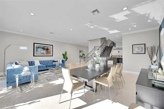 a living room with furniture a large window and a flat screen tv