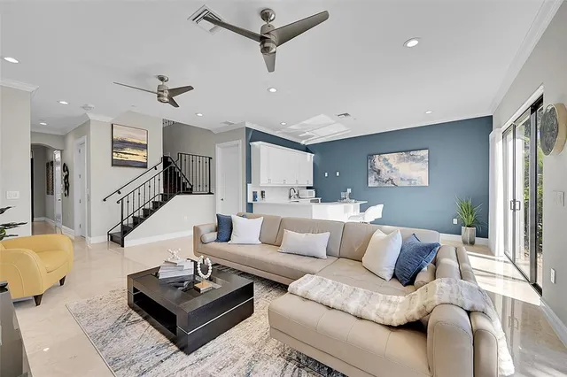 a kitchen with stainless steel appliances kitchen island a table and chair in it