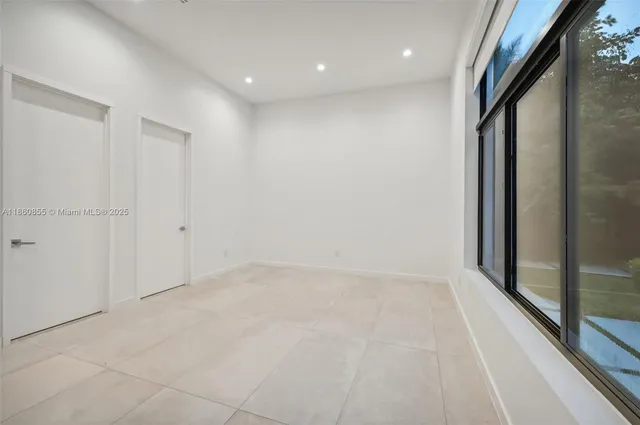 a bathroom with a shower sink mirror and toilet