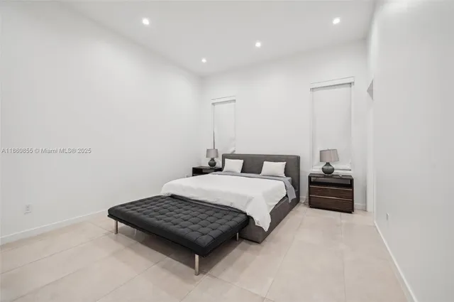 a bathroom with a toilet a sink a glass door a shower and a mirror