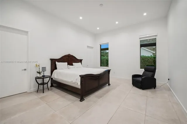 a bedroom with bed and a couch