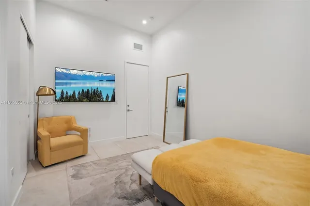 a bedroom with a large bed and a large window