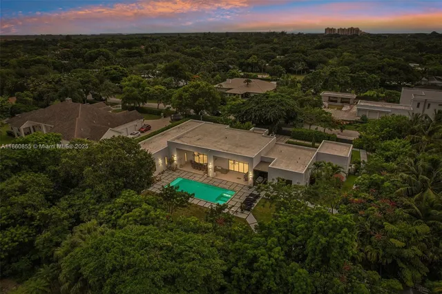 a house with green field in front of it