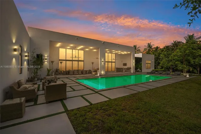 a view of a patio with table and chairs and potted plants
