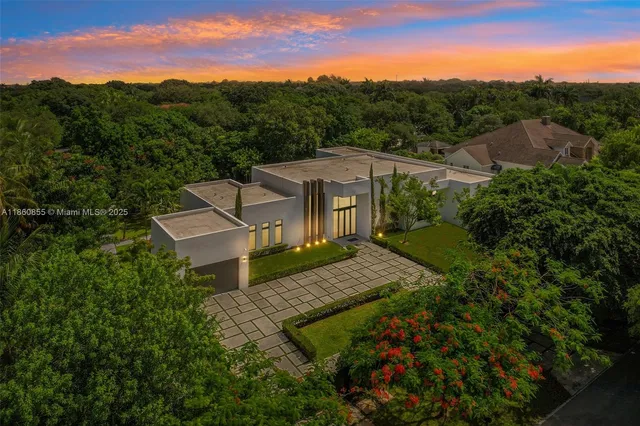 a view of a house with swimming pool and sitting area