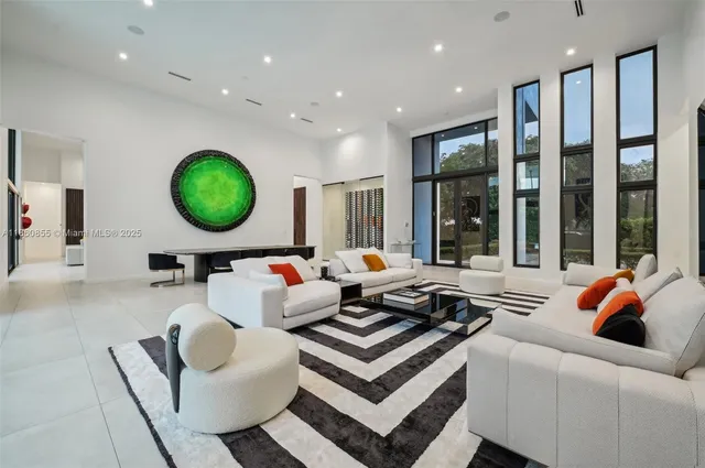 a living room with furniture and large windows