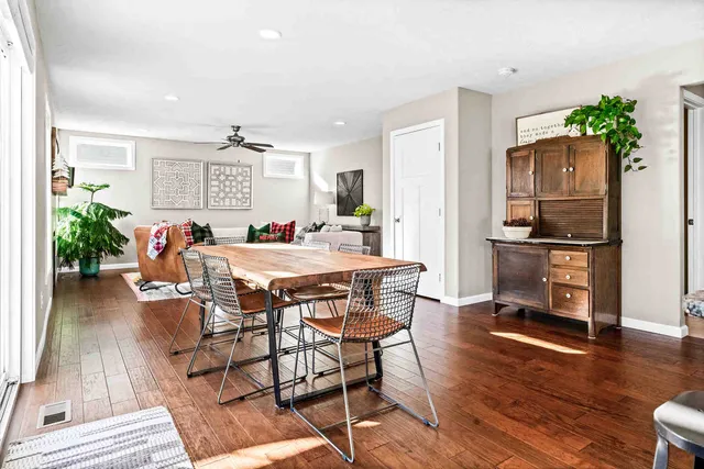 a dining room with furniture and wooden floor