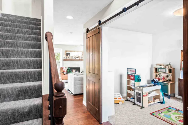 a living room with furniture and a book shelf