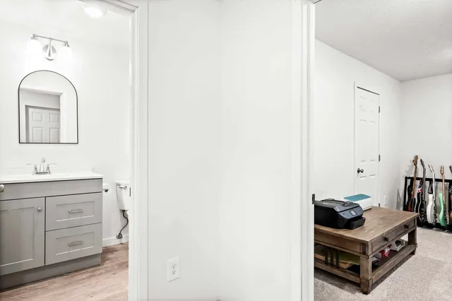 a bathroom with a sink a toilet and a mirror