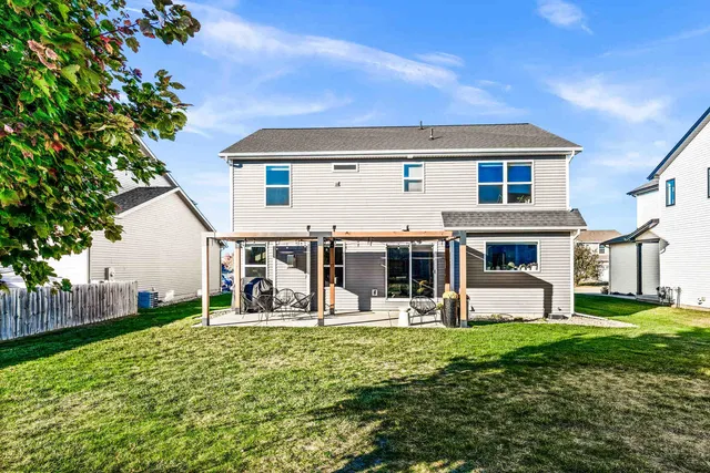 a view of a patio with table and chairs potted plants with floor to ceiling window