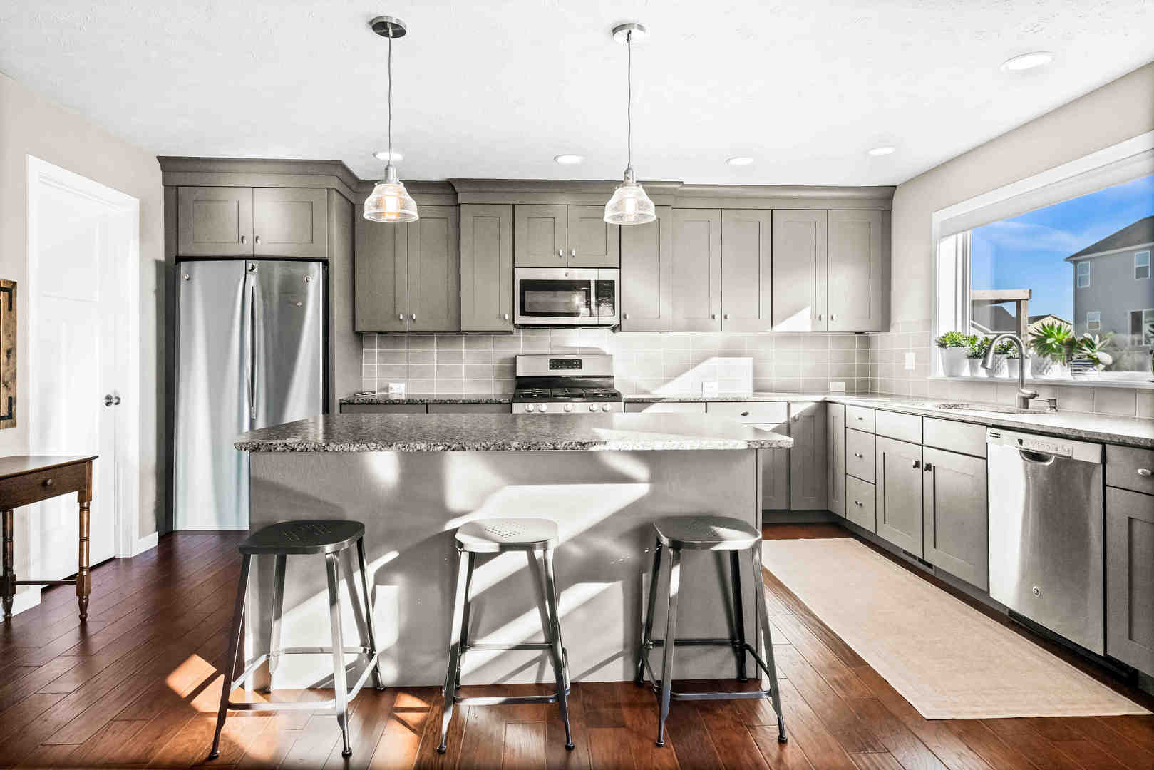 3615 Silverado Trail Normal, IL 61761 - Photo 9 of 37 a kitchen with stainless steel appliances granite countertop a stove top oven a refrigerator a sink and chairs