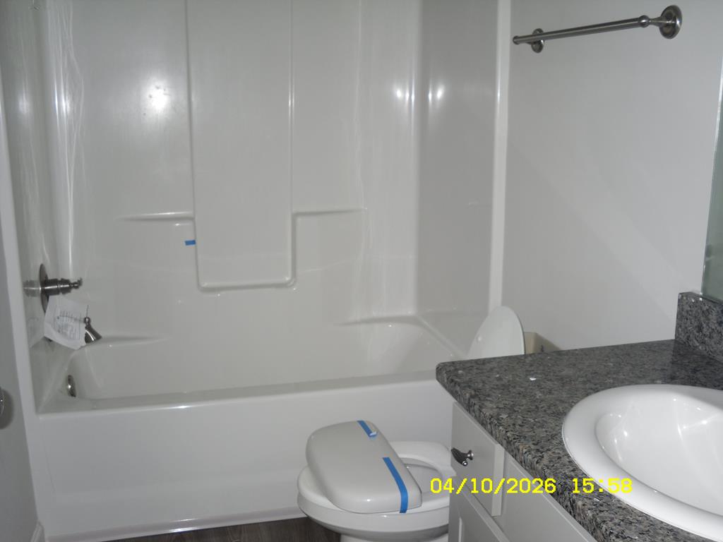 1325 Hawkins Road Woodland, GA 31836 - Photo 21 of 22 a bathroom with a granite countertop sink toilet and bathtub