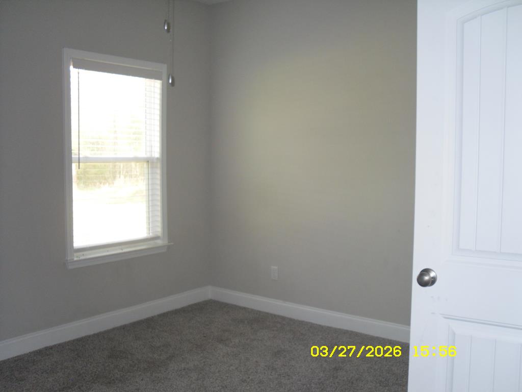 1325 Hawkins Road Woodland, GA 31836 - Photo 22 of 22 an empty room with a window