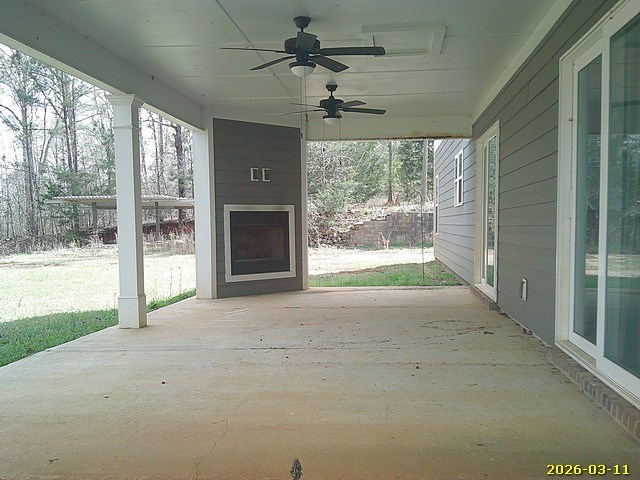 1325 Hawkins Road Woodland, GA 31836 - Photo 3 of 22 a view of an empty room with a fireplace and a large window