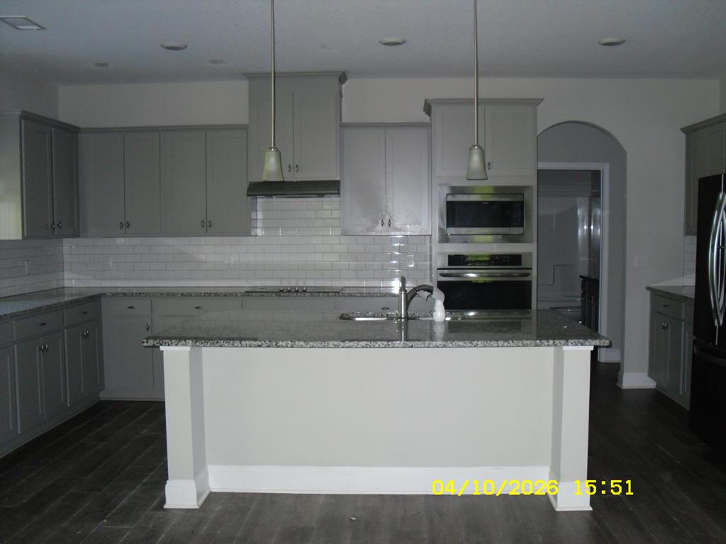 1325 Hawkins Road Woodland, GA 31836 - Photo 9 of 22 a kitchen with stainless steel appliances granite countertop a sink a stove and a refrigerator