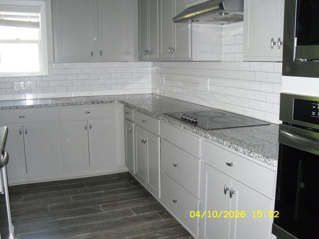 1325 Hawkins Road Woodland, GA 31836 - Photo 10 of 22 a kitchen with granite countertop white cabinets and a sink