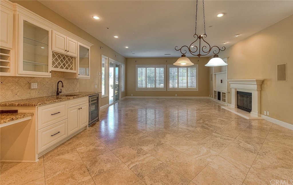 16 Bent Oak Coto de Caza, CA 92679 - Photo 25 of 56 a large kitchen with kitchen island a stove a sink a chandelier and a fireplace